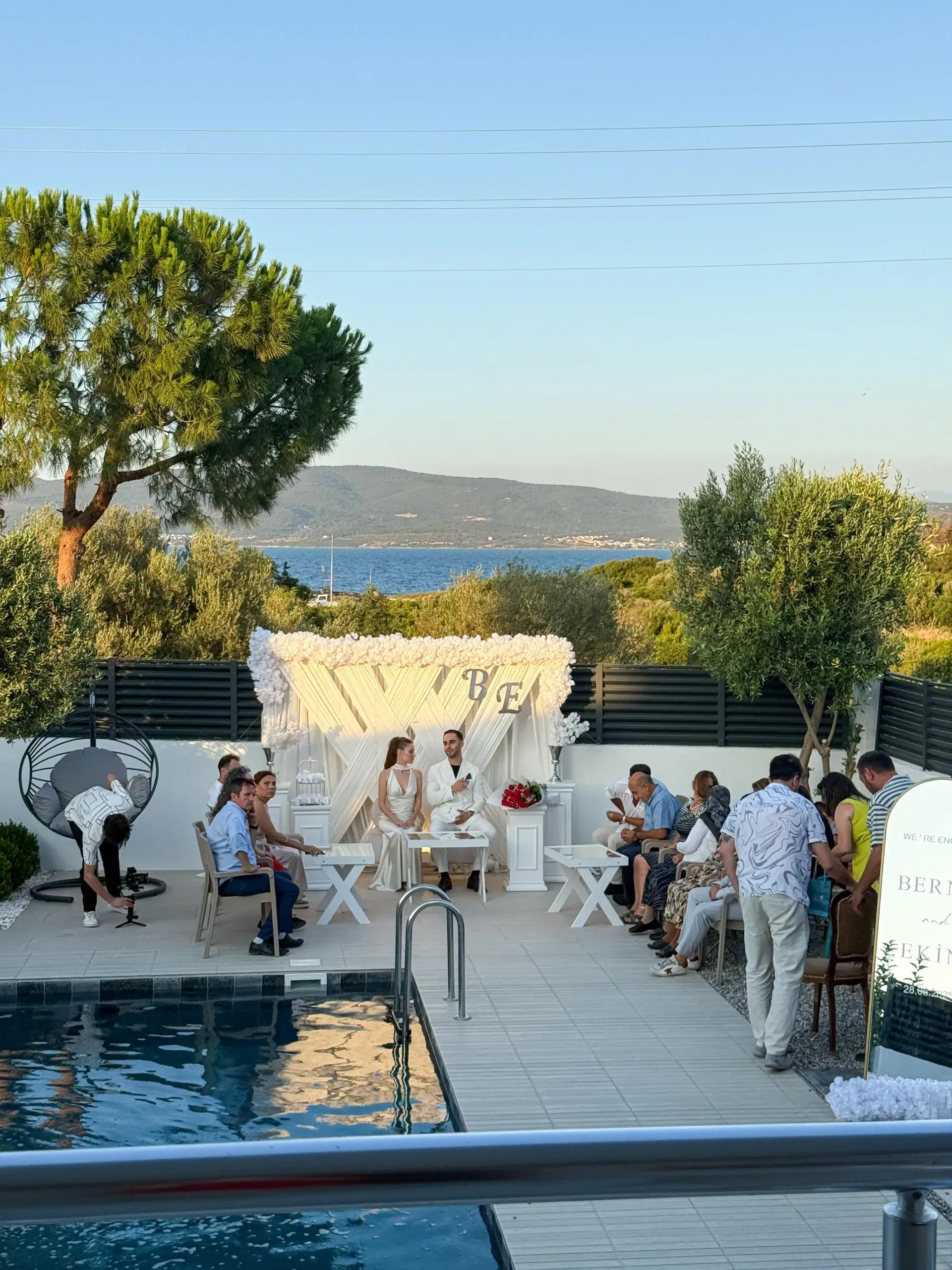 Wide view of outdoor engagement ceremony setup at Villa Öz with guests seated