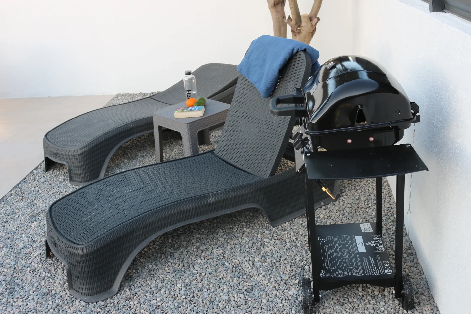 Sun loungers and BBQ grill by the pool