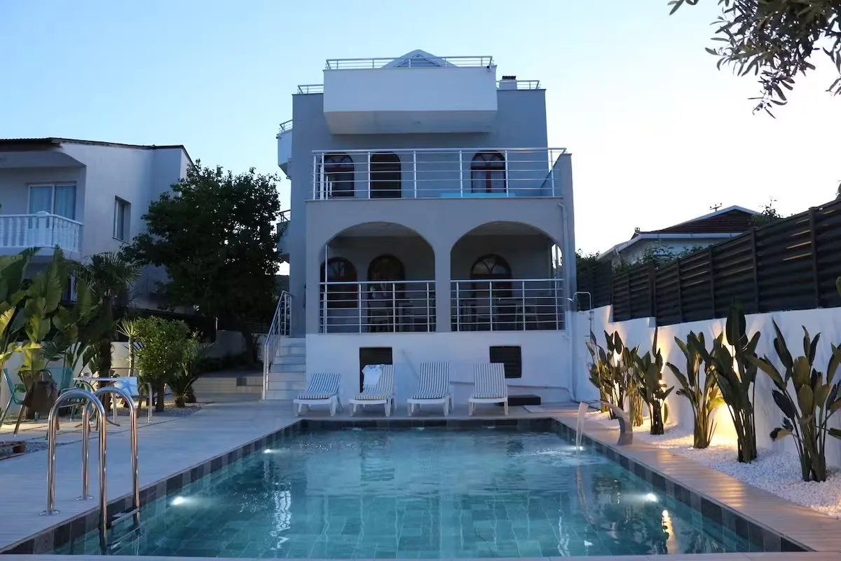 Villa exterior and pool area at dusk
