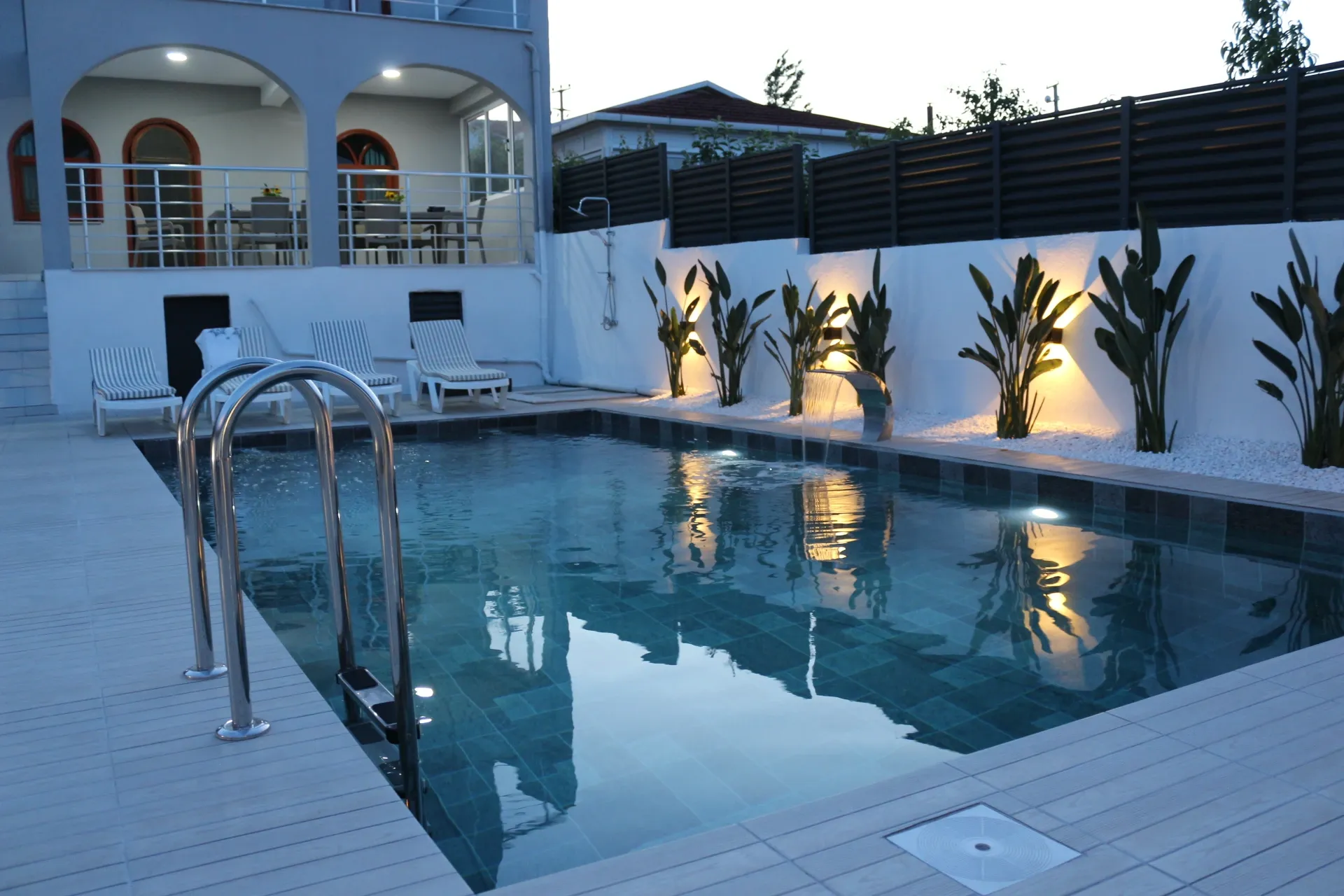 Villa Öz exterior with pool at evening